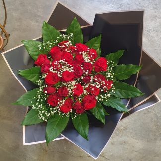 Red rose bunch in black paper
